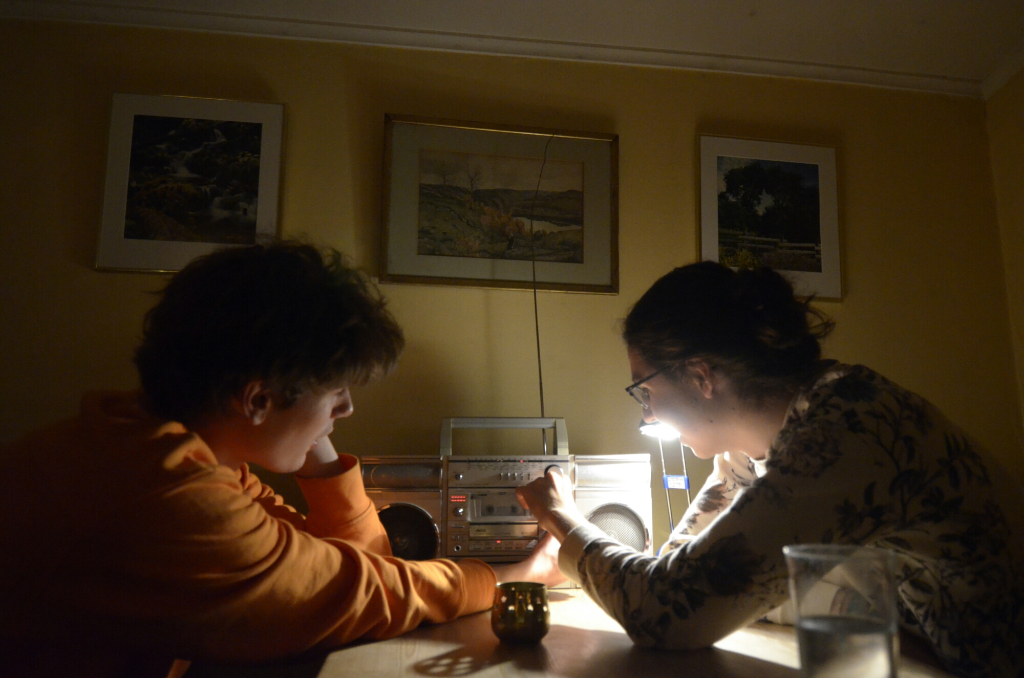 two guys playing with an oldschool boombox